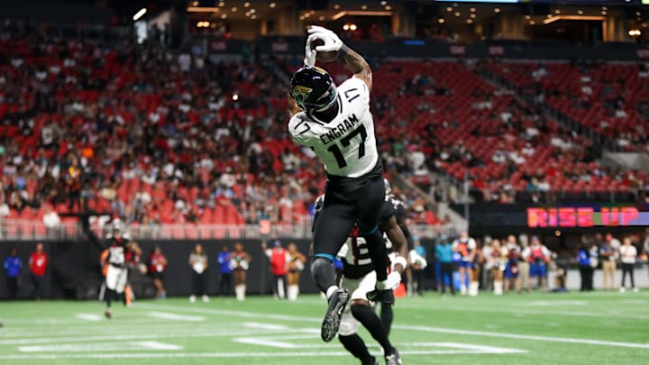 Aug 23, 2024; Atlanta, Georgia, USA; Jacksonville Jaguars tight end Evan Engram (17) catches a touchdown pass past Atlanta Falcons cornerback Anthony Johnson (43) in the second quarter at Mercedes-Benz Stadium. 