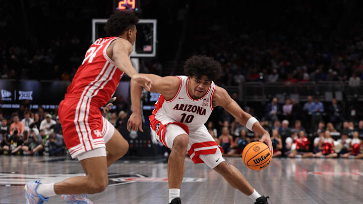 Mar 14, 2026; Kansas City, MO, USA; Arizona Wildcats forward Koa Peat (10) drives to the hoop past Houston Cougars forward Chase McCarty (24) during the first half during the men's Big 12 Conference Tournament Championship at T-Mobile Center. Mandatory Credit: William Purnell-Imagn Images
