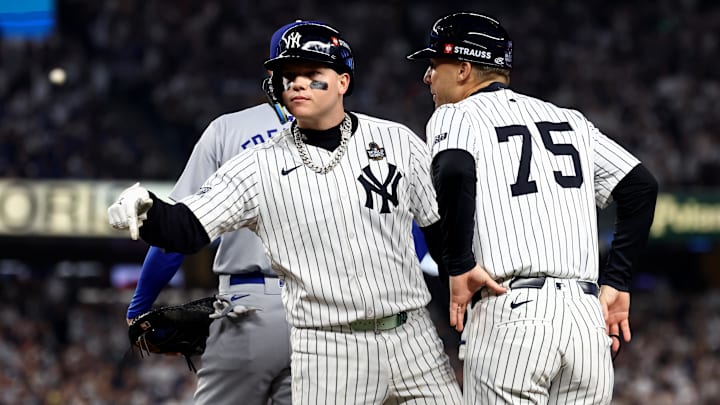 Oct 30, 2024; New York, New York, USA; New York Yankees outfielder Alex Verdugo (24) celebrates with first base coach Travis Chapman (75) after hitting a RBI single during the second inning against the Los Angeles Dodgers in game five of the 2024 MLB World Series at Yankee Stadium. Mandatory Credit: Vincent Carchietta-Imagn Images