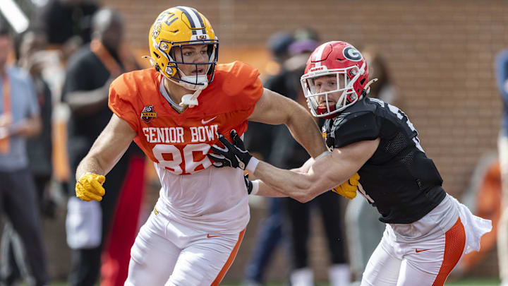 Jan 30, 2025; Mobile, AL, USA; American team tight end Mason Taylor of LSU (86) and American team defensive back Dan Jackson of Georgia (37) spar during Senior Bowl practice for the American team at Hancock Whitney Stadium. Mandatory Credit: Vasha Hunt-Imagn Images