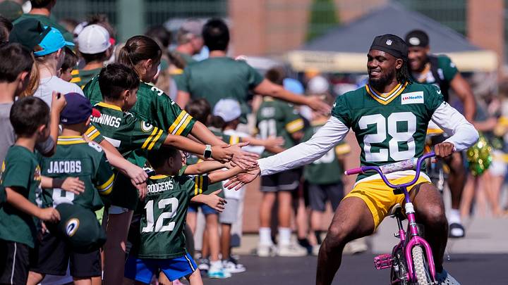 Green Bay Packers cornerback MJ Devonshire Jr. (28) slaps hands with young fans as he rides a bicycle to practice during the first day of training camp on Wednesday, July 29, 2026, at the Don Hutson Center in Ashwaubenon, Wis. Green Bay Packers cornerback MJ Devonshire Jr. (28) slaps hands with young fans as he rides a bicycle to practice during the first day of training camp on Wednesday, July 29, 2026, at the Don Hutson Center in Ashwaubenon, Wis.