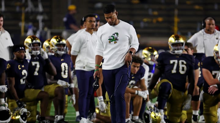 Sep 13, 2025; South Bend, Indiana, USA; Notre Dame Fighting Irish head coach Marcus Freeman looks on as the team takes a knee for Notre Dame Fighting Irish tight end Eli Raridon (9) after an apparent injury against Texas A&M Aggies during the second half at Notre Dame Stadium. Mandatory Credit: Trevor Ruszkowski-Imagn Images Sep 13, 2025; South Bend, Indiana, USA; Notre Dame Fighting Irish head coach Marcus Freeman looks on as the team takes a knee for Notre Dame Fighting Irish tight end Eli Raridon (9) after an apparent injury against Texas A&M Aggies during the second half at Notre Dame Stadium. Mandatory Credit: Trevor Ruszkowski-Imagn Images