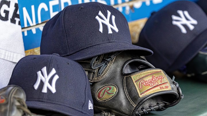 Apr 7, 2025; Detroit, Michigan, USA; New York Yankees baseball hats and gloves in the dugout out in the eighth inning against the Detroit Tigers at Comerica Park.