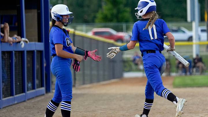 Clear Creek Amana’s Kyla Schulte (15) high-fives Malea Hollenbeck (11) after Hollenbeck scored during a softball game against Mount Vernon June 16, 2025 in Tiffin, Iowa. Clear Creek Amana’s Kyla Schulte (15) high-fives Malea Hollenbeck (11) after Hollenbeck scored during a softball game against Mount Vernon June 16, 2025 in Tiffin, Iowa.