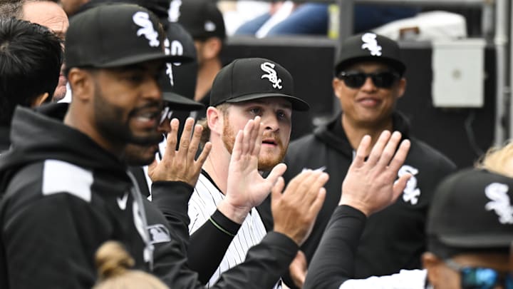 Chicago White Sox pitcher Shane Smith (64) celebrates with teammates in the dugout.