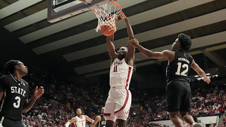 Feb 25, 2025; Tuscaloosa, AL, USA;  Alabama center Clifford Omoruyi (11) gets a put back dunk between Mississippi State forward Keshawn Murphy (3) and Mississippi State guard Josh Hubbard (12) at Coleman Coliseum.