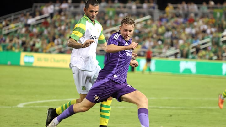 May 7, 2025; St. Petersburg, Florida, USA; Orlando City SC forward Duncan McGuire (13) dribbles the ball as Tampa Bay Rowdies defender Forrest Lasso (3) defends during the second half at Al Lang Stadium. Mandatory Credit: Kim Klement Neitzel-Imagn Images