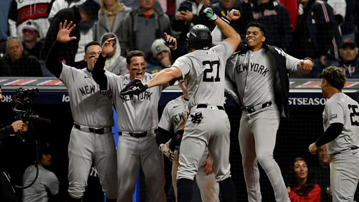 Oct 17, 2024; Cleveland, Ohio, USA; New York Yankees designated hitter Giancarlo Stanton (27) celebrates with teammates after a home run during the eighth inning against the Cleveland Guardians in Game 3 of the American League Championship Series at Progressive Field.