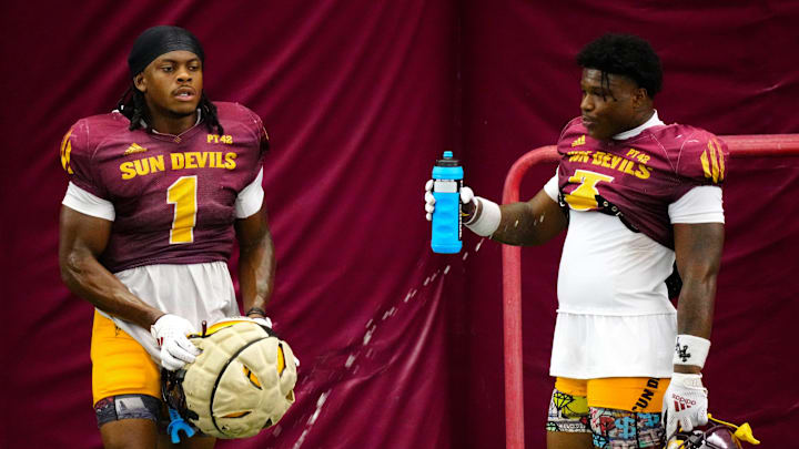 Arizona State running backs Kyson Brown (1) and Raleek Brown (3) take a water break during a practice inside the Verde Dickey Dome in Tempe on August 12, 2025.