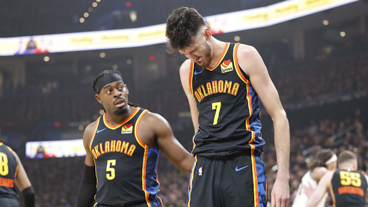 May 5, 2025; Oklahoma City, Oklahoma, USA; Oklahoma City Thunder guard Luguentz Dort (5) checks on forward Chet Holmgren (7) after he was hit during a play against the Denver Nuggets during the first quarter during game one of the second round for the 2025 NBA Playoffs at Paycom Center. Mandatory Credit: Alonzo Adams-Imagn Images