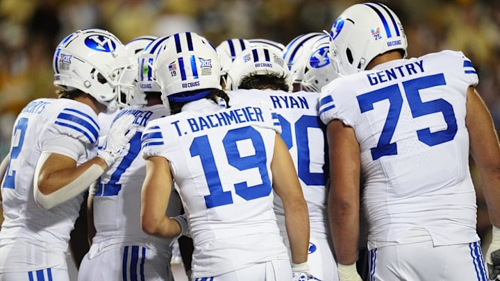 Sep 27, 2025; Boulder, Colorado, USA; Members of the Brigham Young Cougars offensive squad huddle in the second quarter against the Colorado Buffaloes at Folsom Field. Mandatory Credit: Ron Chenoy-Imagn Images
