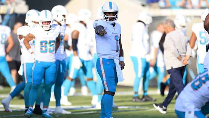 Miami Dolphins quarterback Tua Tagovailoa (1) directs before the game of a preseason matchup