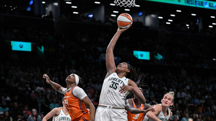 Aug 25, 2025; Brooklyn, New York, USA; New York Liberty center Jonquel Jones (35) rebounds the ball against Connecticut Sun forward Aneesah Morrow (24) during the second half at Barclays Center. 