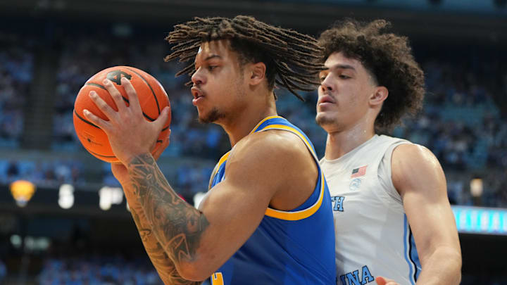Feb 14, 2026; Chapel Hill, North Carolina, USA; Pittsburgh Panthers forward Cameron Corhen (2) with the ball as North Carolina Tar Heels forward Zayden High (1) defends in the first half at Dean E. Smith Center. Mandatory Credit: Bob Donnan-Imagn Images