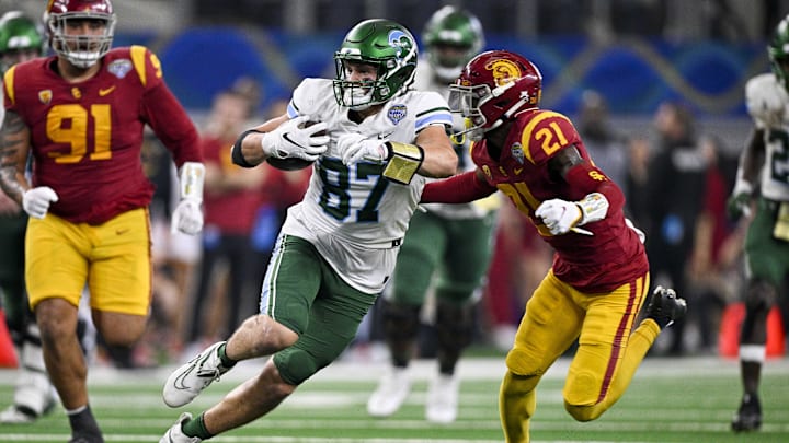 Jan 2, 2023; Arlington, Texas, USA; Tulane Green Wave tight end Alex Bauman (87) and USC Trojans defensive back Latrell McCutchin (21) in action during the game between the USC Trojans and the Tulane Green Wave in the 2023 Cotton Bowl at AT&T Stadium. Mandatory Credit: Jerome Miron-Imagn Images