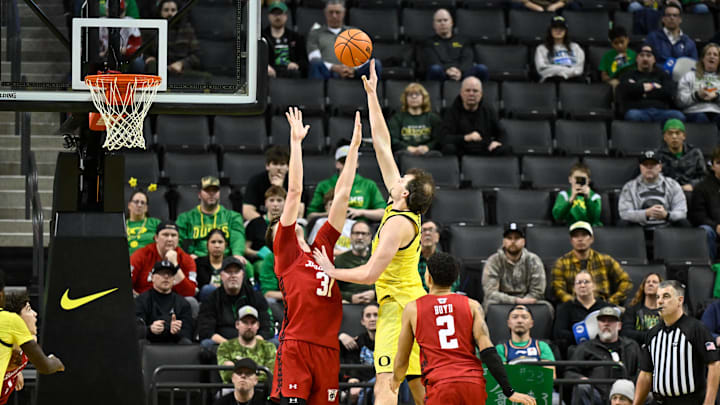 Feb 25, 2026; Eugene, Oregon, USA; Oregon Ducks center Nate Bittle (32) shoots the ball over Wisconsin Badgers forward Nolan Winter (31) during the second half at Matthew Knight Arena. Mandatory Credit: Craig Strobeck-Imagn Images