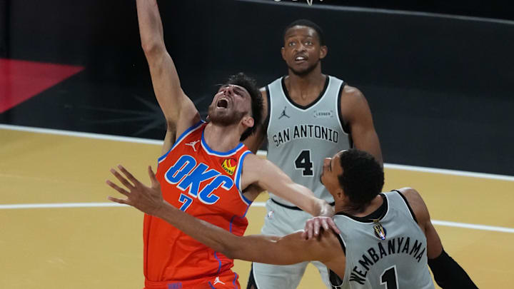Dec 13, 2025; Las Vegas, Nevada, USA; Oklahoma City Thunder center Chet Holmgren (7) throws up the shot as San Antonio Spurs forward Victor Wembanyama (1) defends during the second half at T-Mobile Arena. Mandatory Credit: Kirby Lee-Imagn Images