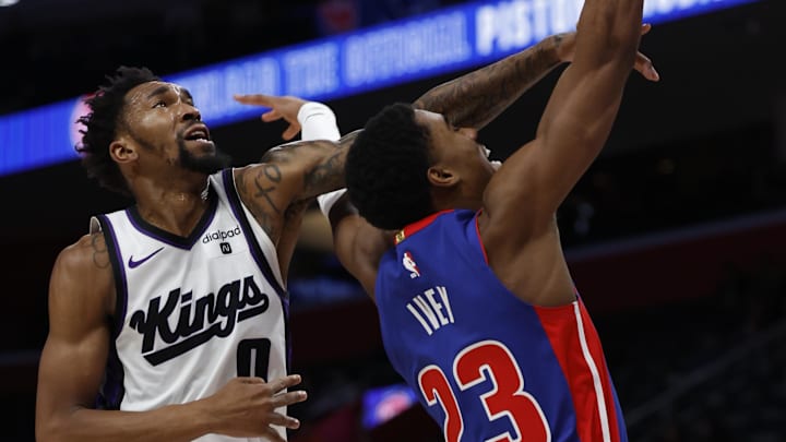 Jan 9, 2024; Detroit, Michigan, USA;  Detroit Pistons guard Jaden Ivey (23) shoots and is fouled by Sacramento Kings guard Malik Monk (0) in the second half at Little Caesars Arena. Mandatory Credit: Rick Osentoski-USA TODAY Sports