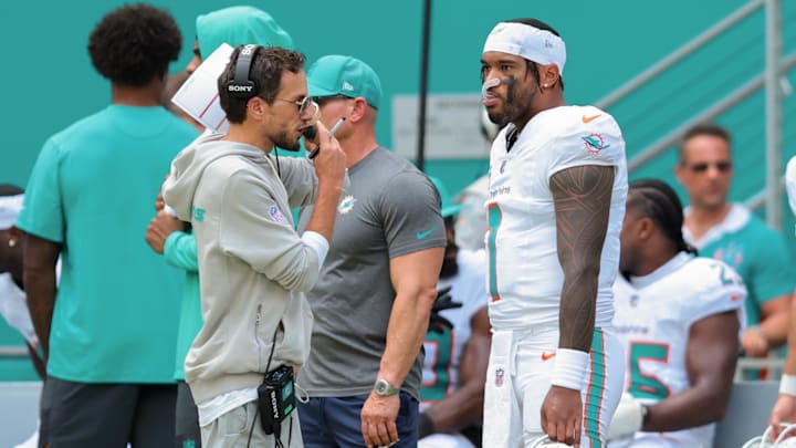 Miami Dolphins head coach Mike McDaniel and quarterback Tua Tagovailoa (1) stand on the sideline against the New England Patriots during the second quarter at Hard Rock Stadium. 