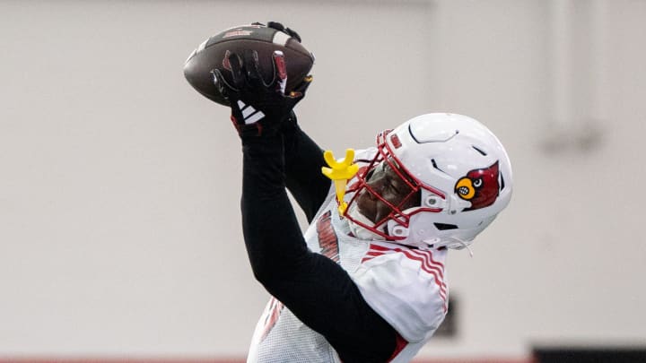 Louisville football wide receiver Chris Bell (0) runs drills during spring practice on Saturday,