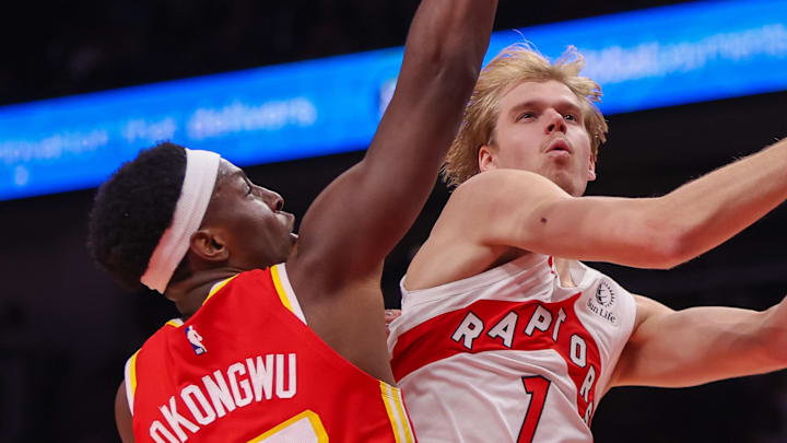 Toronto Raptors guard Gradey Dick shoots past Atlanta Hawks forward Onyeka Okongwu.