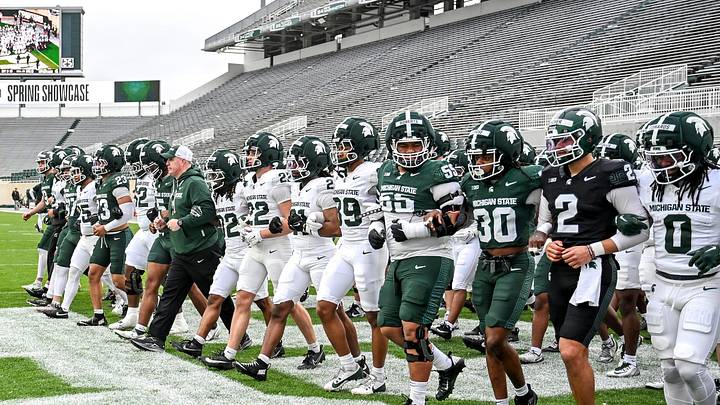 Michigan State's head coach Pat Fitzgerald and the team walk across the end zone during the football Spring Showcase on Saturday, April 18, 2026, at Spartan Stadium in East Lansing. Michigan State's head coach Pat Fitzgerald and the team walk across the end zone during the football Spring Showcase on Saturday, April 18, 2026, at Spartan Stadium in East Lansing.