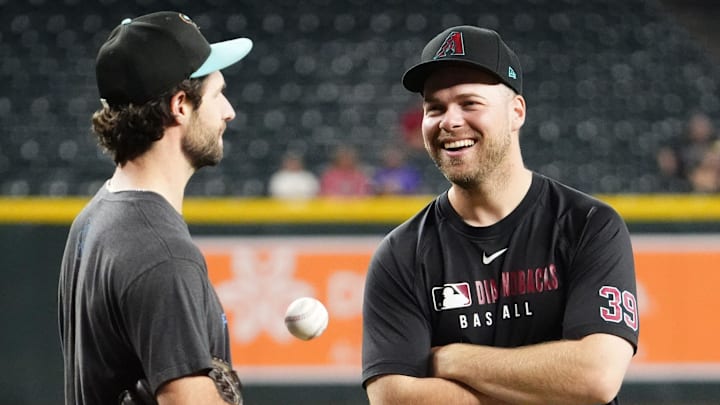 Arizona Diamondbacks pitchers Zac Gallen and Corbin Burnes talk before playing the San Francisco Giants at Chase Field on Sept. 17, 2025. Arizona Diamondbacks pitchers Zac Gallen and Corbin Burnes talk before playing the San Francisco Giants at Chase Field on Sept. 17, 2025.