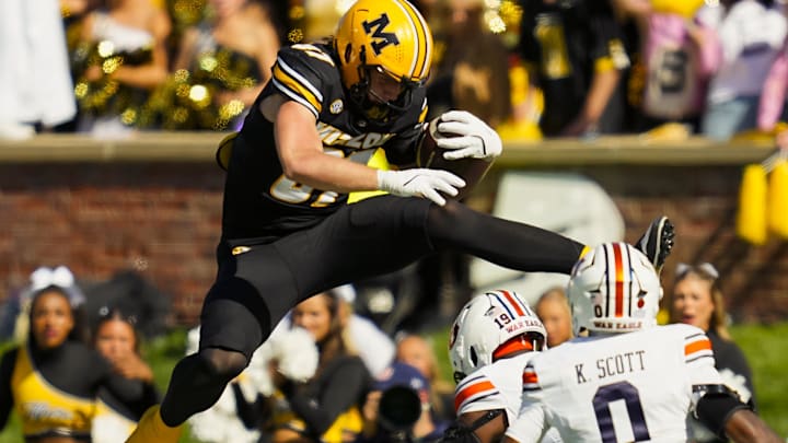 Oct 19, 2024; Columbia, Missouri, USA; Missouri Tigers tight end Brett Norfleet (87) hurdles Auburn Tigers safety Sylvester Smith (19) during the second half at Faurot Field at Memorial Stadium. Mandatory Credit: Jay Biggerstaff-Imagn Images