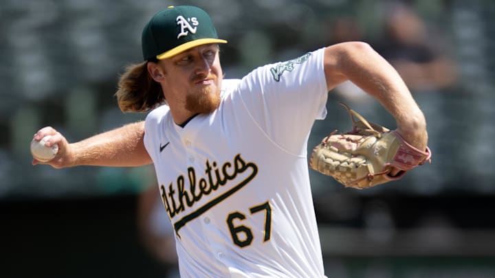 Aug 22, 2024; Oakland, California, USA; Oakland Athletics pitcher Grant Holman (67) delivers a pitch against the Tampa Bay Rays during the seventh inning at Oakland-Alameda County Coliseum. Mandatory Credit: D. Ross Cameron-Imagn Images