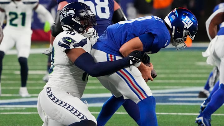 Oct 2, 2023; East Rutherford, New Jersey, USA; New York Giants quarterback Daniel Jones (8) is sacked by Seattle Seahawks linebacker Uchenna Nwosu (10) in the second half at MetLife Stadium.
