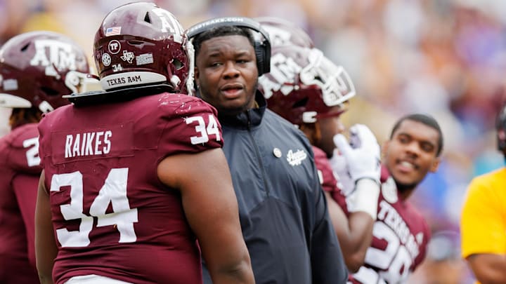 Nov 25, 2023; Baton Rouge, Louisiana, USA;  Texas A&M Aggies interim head coach Elijah Robinson talks to defensive lineman Isaiah Raikes (34) on a time out against the LSU Tigers during the second half at Tiger Stadium. Mandatory Credit: Stephen Lew-Imagn Images