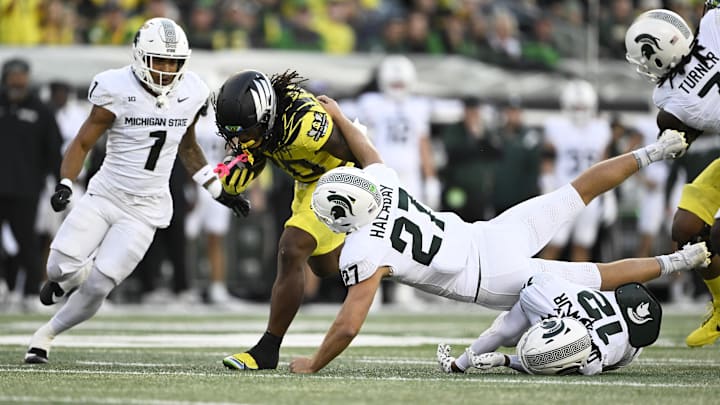Oct 4, 2024; Eugene, Oregon, USA; Oregon Ducks running back Jordan James (20) picks up a first down during the first half against Michigan State Spartans linebacker Cal Haladay (27) at Autzen Stadium. Mandatory Credit: Troy Wayrynen-Imagn Images