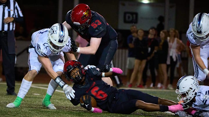 Chaparral Firebirds junior wide receiver Plas Johnson (6) is brought down by the Pinnacle defense at Chaparral High School   s football field in Scottsdale on Oct. 14, 2022.