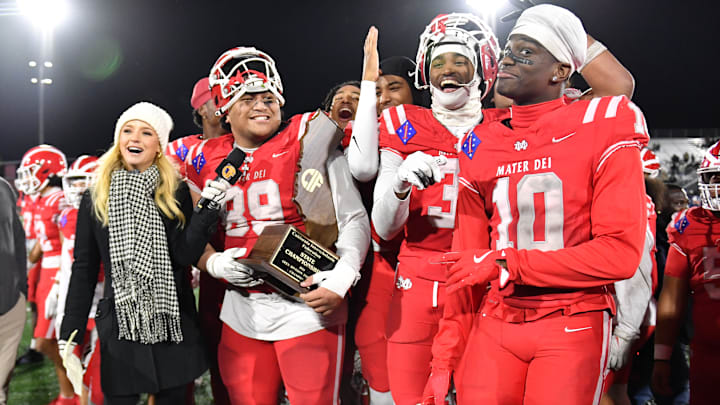 Mater Dei football players are all smiles with the 2024 CIF State Open Division trophy after beating De La Salle 37-15 at Saddleback College.