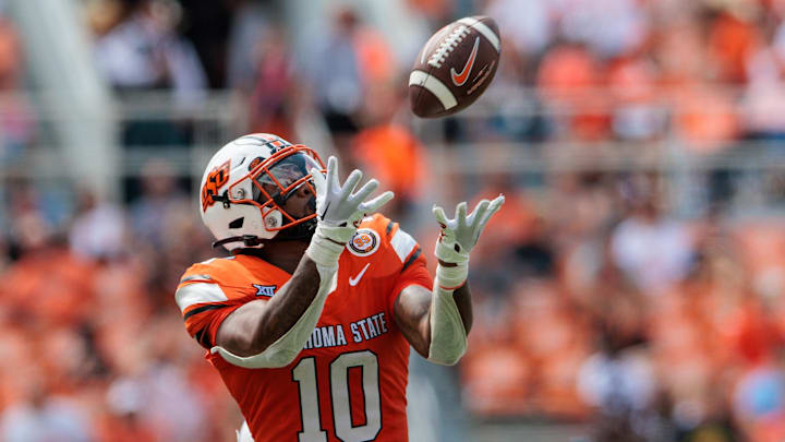 Aug 31, 2024; Stillwater, Oklahoma, USA; Oklahoma State Cowboys wide receiver Rashod Owens (10) reaches for a pass during the third quarter against the South Dakota State Jackrabbits at Boone Pickens Stadium. Mandatory Credit: William Purnell-Imagn Images