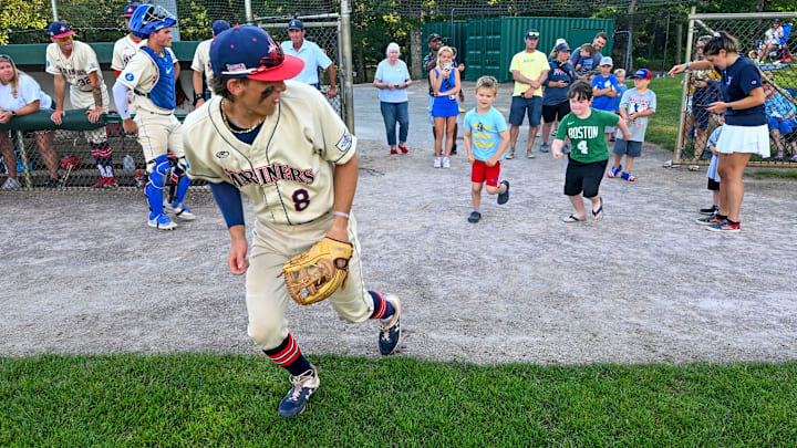 HARWICH 06/24/24 Harwich third baseman Jake Ogden leads young fans out on the field for the National Anthem before the game with Chatham. Going to a Cape League baseball game in Harwich
Ron Schloerb/Cape Cod Times
