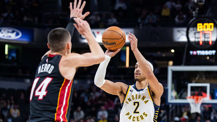 Jan 10, 2026; Indianapolis, Indiana, USA; Indiana Pacers guard/forward Andrew Nembhard (2) shoots the ball while Miami Heat guard Tyler Herro (14) defends in the first half at Gainbridge Fieldhouse. Mandatory Credit: Trevor Ruszkowski-Imagn Images