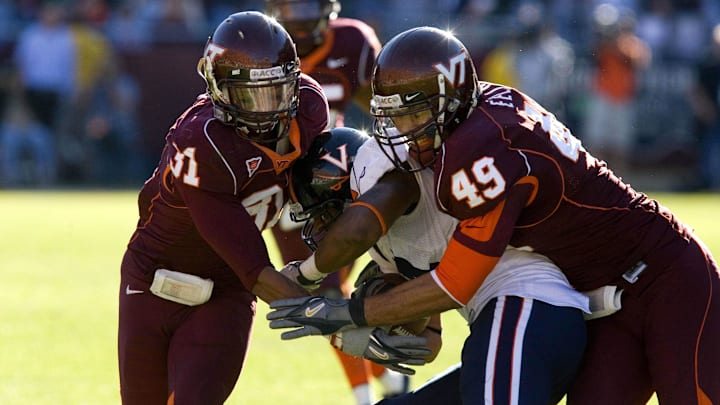 Nov. 25, 2006, Blacksburg, Va, USA; Virginia Cavaliers wide receiver (84) Fontel Mines is tackled by linebacker (31) Brenden Hill and defensive end (49) Chris Ellis in the Hokies 17-0 victory over the Virginia Cavaliers at Lane Stadium in Blacksburg, VA. Mandatory Credit: Bob Donnan-Imagn Images Copyright © 2006 Bob Donnan Nov. 25, 2006, Blacksburg, Va, USA; Virginia Cavaliers wide receiver (84) Fontel Mines is tackled by linebacker (31) Brenden Hill and defensive end (49) Chris Ellis in the Hokies 17-0 victory over the Virginia Cavaliers at Lane Stadium in Blacksburg, VA. Mandatory Credit: Bob Donnan-Imagn Images Copyright © 2006 Bob Donnan