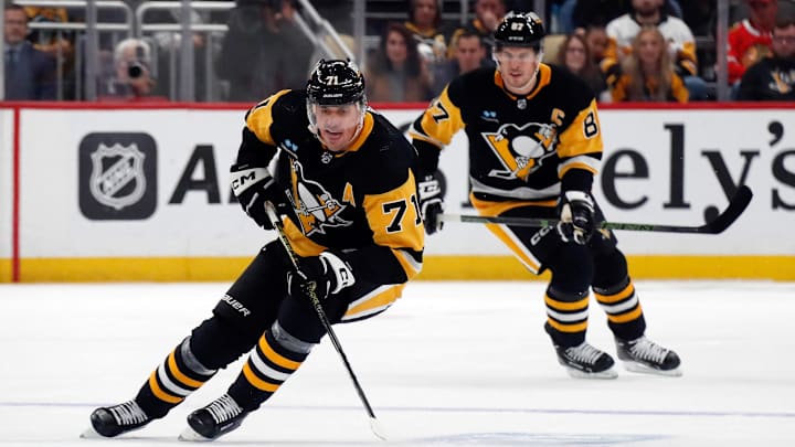 Oct 10, 2023; Pittsburgh, Pennsylvania, USA;  Pittsburgh Penguins center Evgeni Malkin (71) skates with the puck along with center Sidney Crosby (87) against the Chicago Blackhawks during the first period at the PPG Paints Arena. Mandatory Credit: Charles LeClaire-Imagn Images