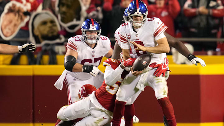 Nov 1, 2021; Kansas City, Missouri, USA; Kansas City Chiefs defensive end Frank Clark (55) strips the ball from New York Giants quarterback Daniel Jones (8) during the second half at GEHA Field at Arrowhead Stadium. Mandatory Credit: Jay Biggerstaff-Imagn Images