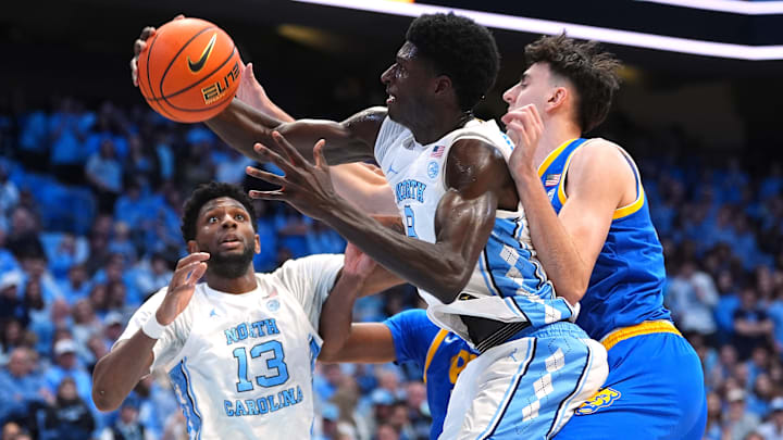 Drake Powell grabs the ball as Jalen Washington boxes out versus Pittsburgh