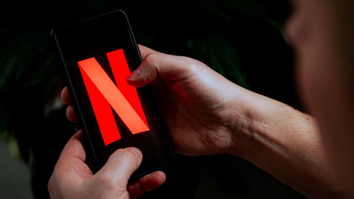 In this photo illustration a Netflix logo seen displayed on...