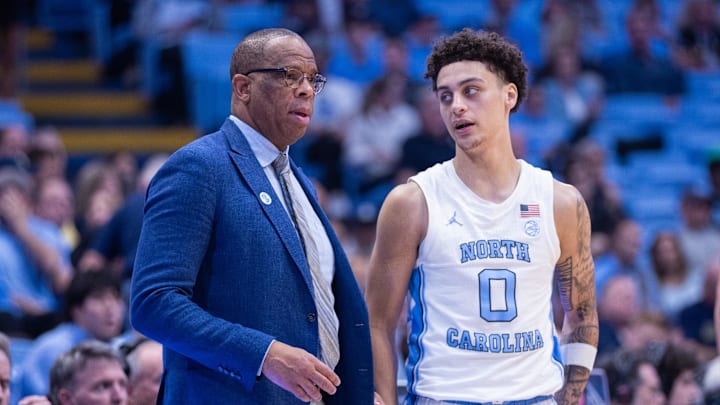 Nov 18, 2025; Chapel Hill, North Carolina, USA; North Carolina Tar Heels head coach Hubert Davis talks to guard Kyan Evans (0) during the second half against the Navy Midshipmen at Dean E. Smith Center. Mandatory Credit: Scott Kinser-Imagn Images
