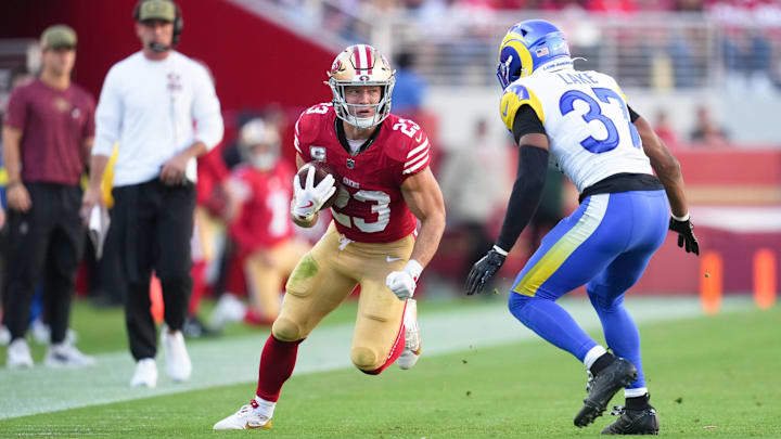 Nov 9, 2025; Santa Clara, California, USA; San Francisco 49ers running back Christian McCaffrey (23) runs the ball against Los Angeles Rams safety Quentin Lake (37) during the second quarter at Levi's Stadium. Mandatory Credit: Cary Edmondson-Imagn Images