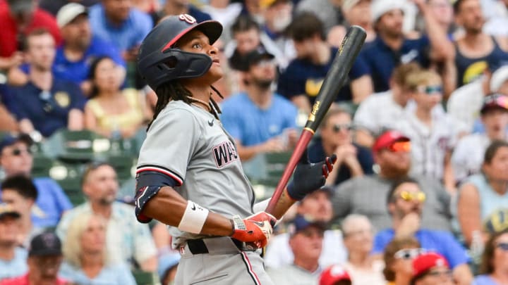 Jul 13, 2024; Milwaukee, Wisconsin, USA; Washington Nationals shortstop C.J. Abrams (5) hits a 2-run home run against the Milwaukee Brewers in the ninth inning at American Family Field. 