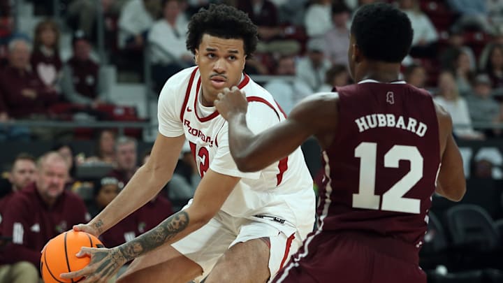Arkansas Razorbacks forward Malique Ewin (12) handles the ball as Mississippi State Bulldogs guard Josh Hubbard (12) defends during the first half at Humphrey Coliseum in Starkville, Miss.