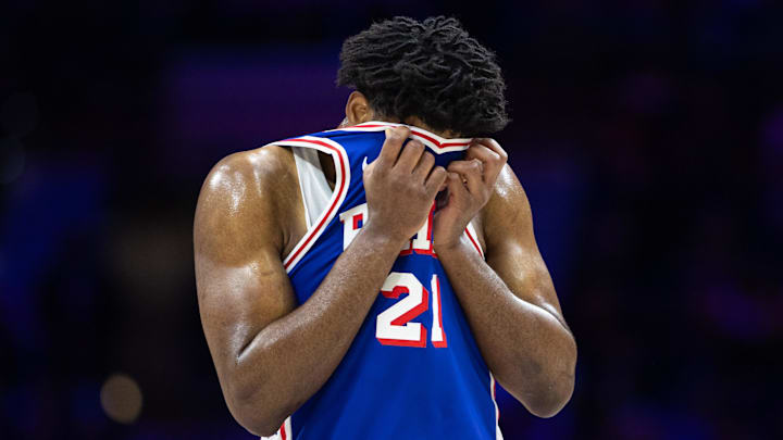 Feb 20, 2025; Philadelphia, Pennsylvania, USA; Philadelphia 76ers center Joel Embiid (21) wipes his face during a break in the third quarter against the Boston Celtics at Wells Fargo Center. Mandatory Credit: Bill Streicher-Imagn Images