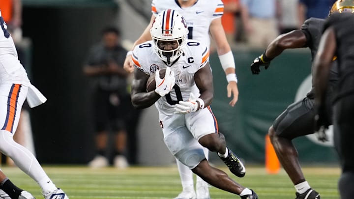 Aug 29, 2025; Waco, Texas, USA;  Auburn Tigers running back Damari Alston (0) runs the ball against the Baylor Bears during the first half at McLane Stadium. Mandatory Credit: Chris Jones-Imagn Images
