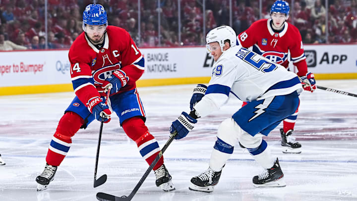 Apr 26, 2026; Montreal, Quebec, CAN; Tampa Bay Lightning center Jake Guentzel (59) defends the puck against Montreal Canadiens center Nick Suzuki (14) during the third period in game four of the first round of the 2026 Stanley Cup Playoffs at Bell Centre. Mandatory Credit: David Kirouac-Imagn Images