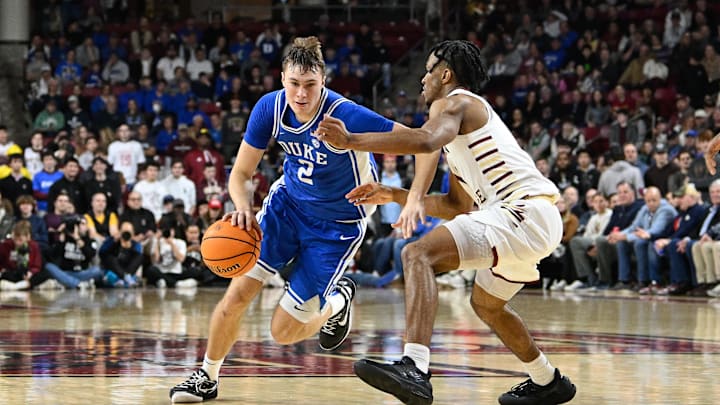Jan 18, 2025; Chestnut Hill, Massachusetts, USA; Duke Blue Devils guard Cooper Flagg (2) dribbles the ball against Boston College Eagles guard Donald Hand Jr. (13) during the second half at Conte Forum. Mandatory Credit: Eric Canha-Imagn Images